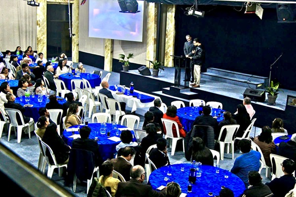 Over 100 pastors and leaders from Cochabamba gathered at tables for a dinner announcing the reopening of RHEMA Bolivia