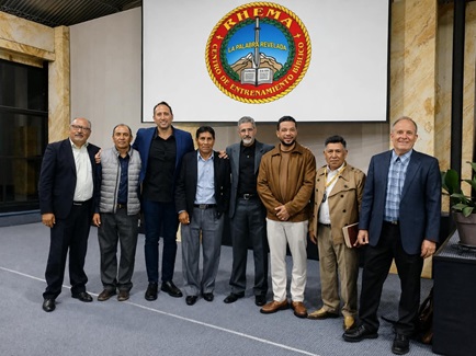 Leaders standing together under the RHEMA Bolivia seal in Cochabamba