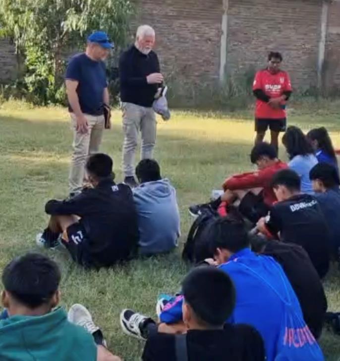 David sharing the gospel with a soccer team in Bolivia